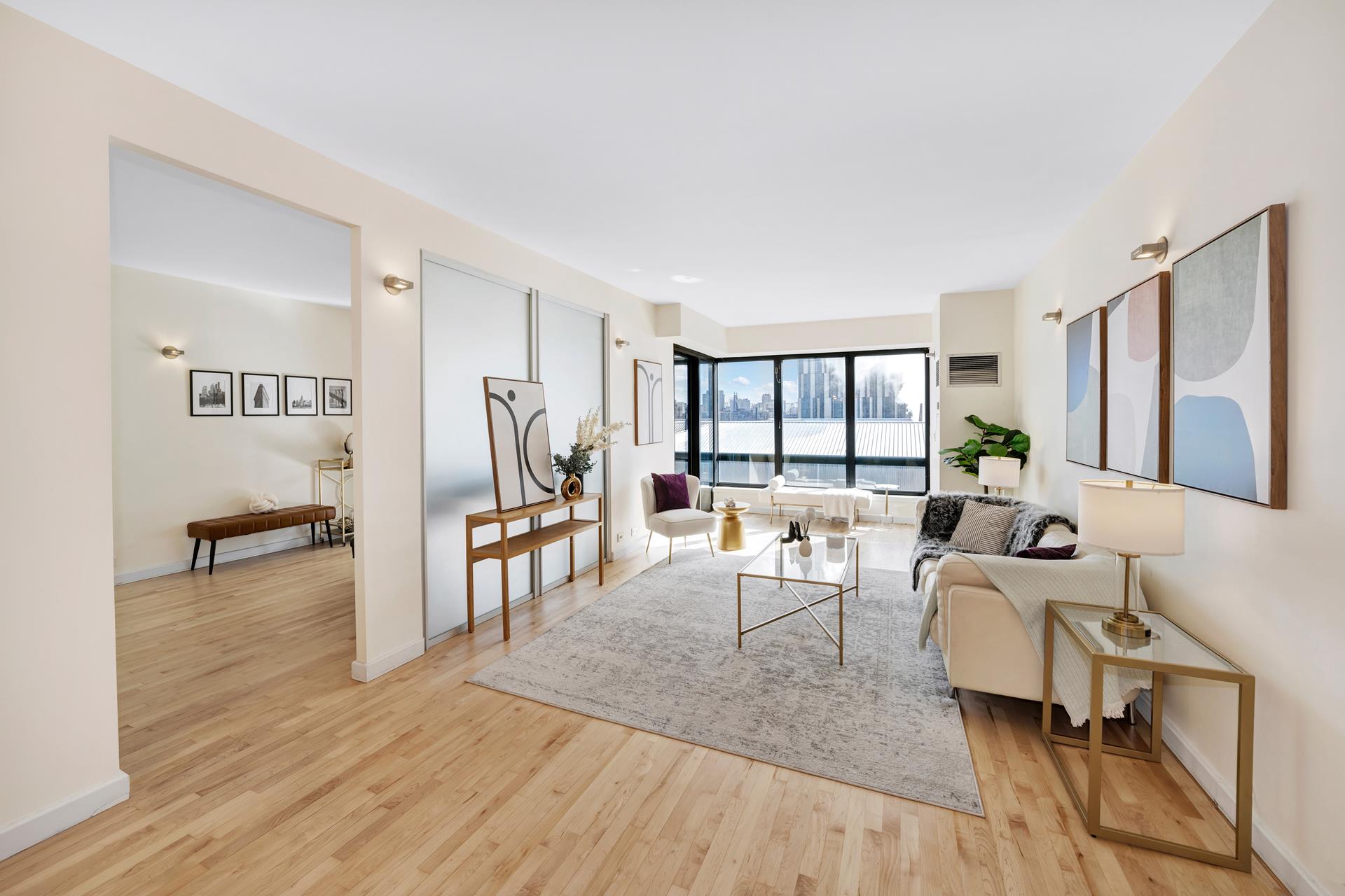 a living room with furniture and a wooden floor