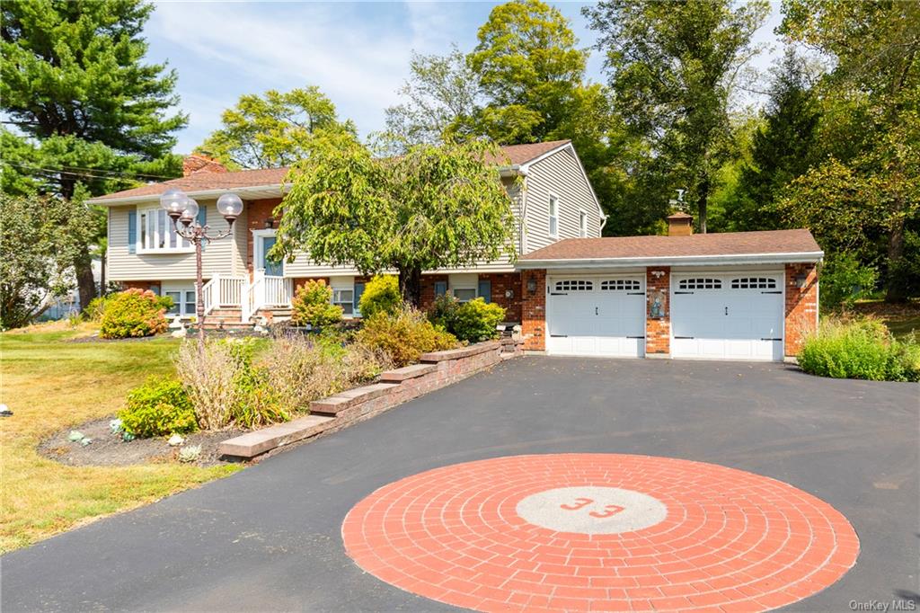 View of front of home featuring a garage and a front lawn