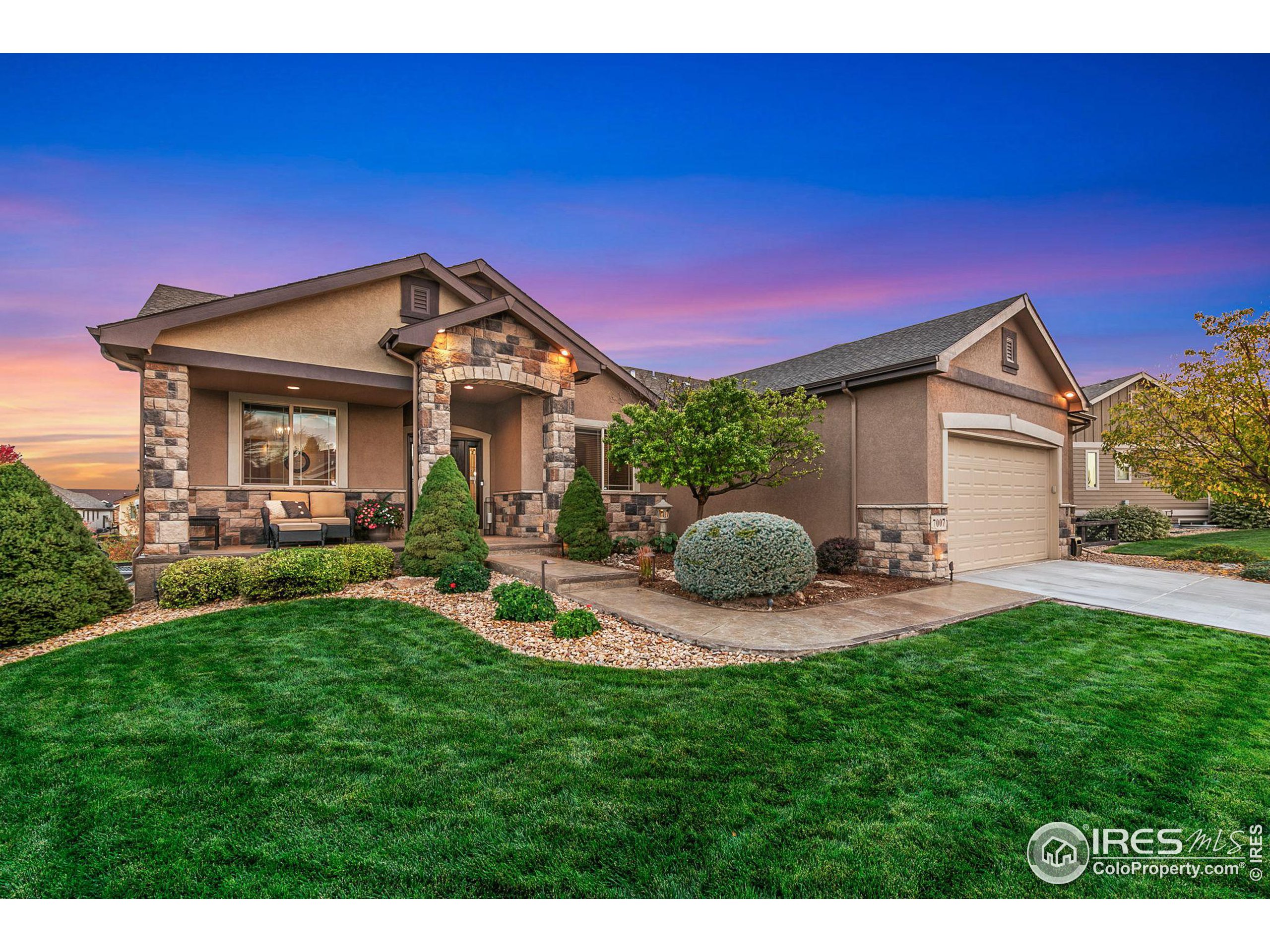 a front view of a house with a yard patio and fire pit