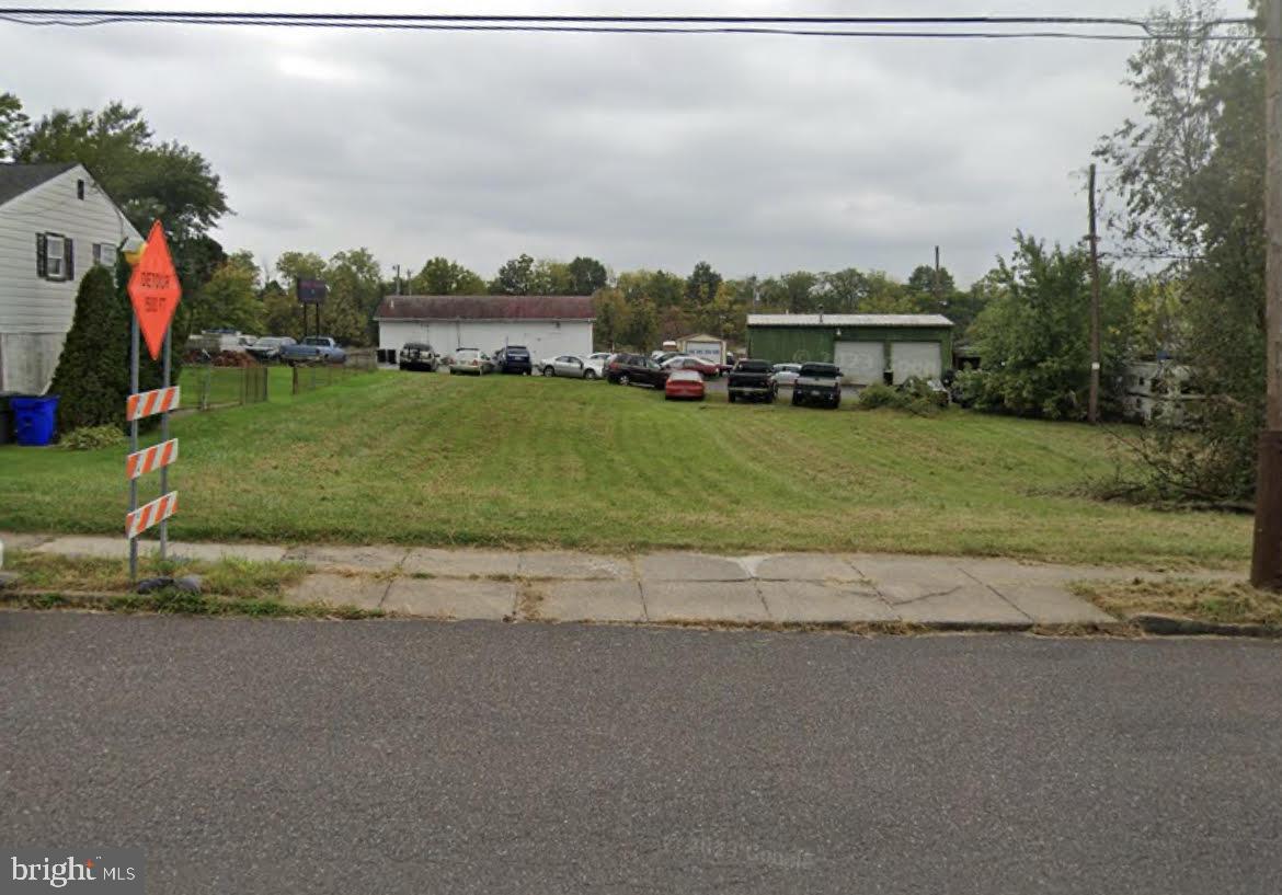 a front view of a house with a yard and road