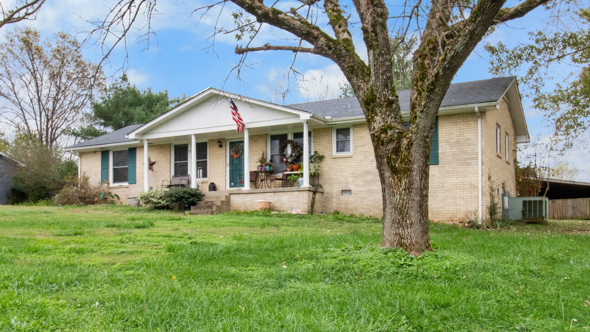 a front view of house with yard and green space