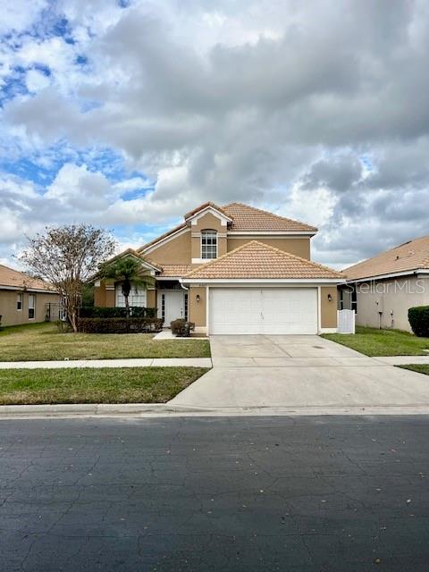 a front view of a house with a yard and garage