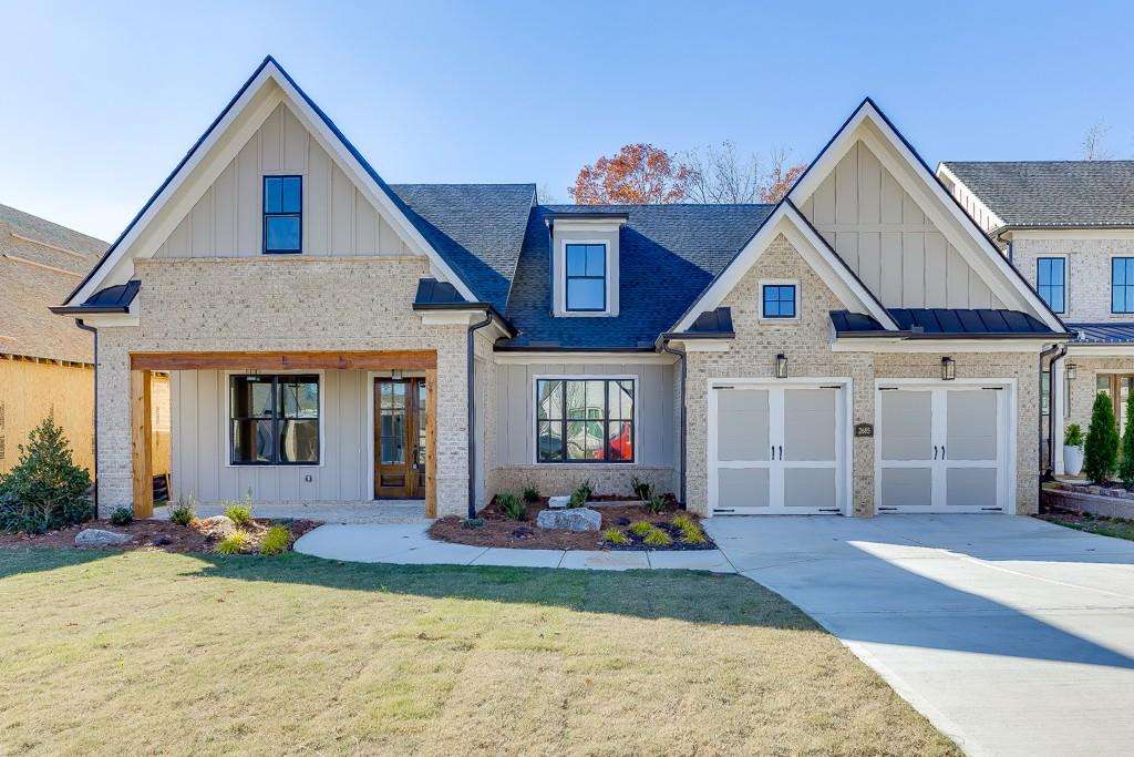 a front view of a house with a yard and porch