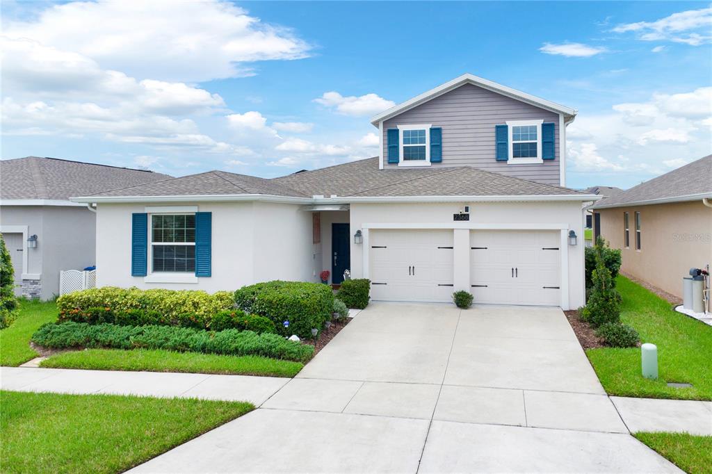 a front view of a house with a yard and garage