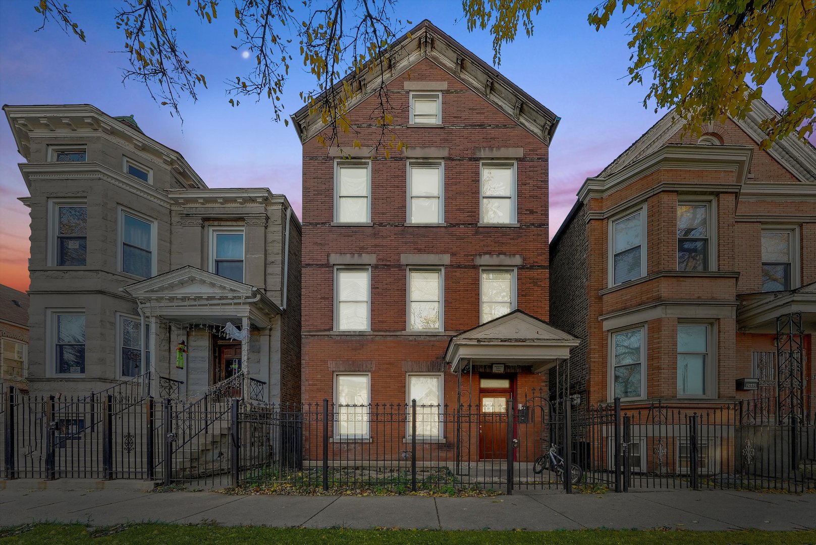 a front view of a residential apartment building with a yard