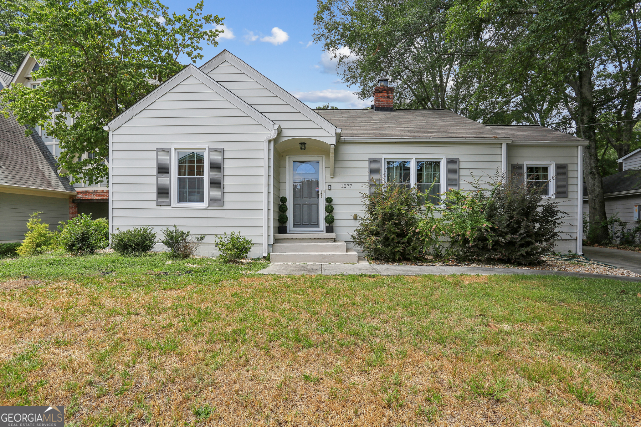 a front view of house with yard and green space