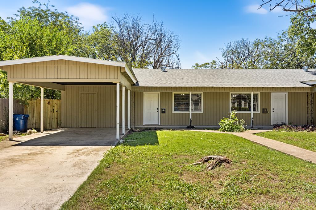 a front view of a house with a yard and porch