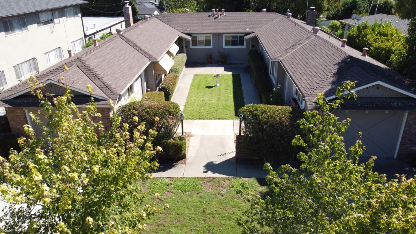 an aerial view of a house with a yard and garden