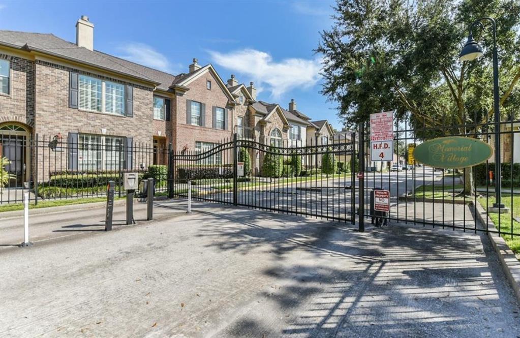 a view of a brick house in front of a yard