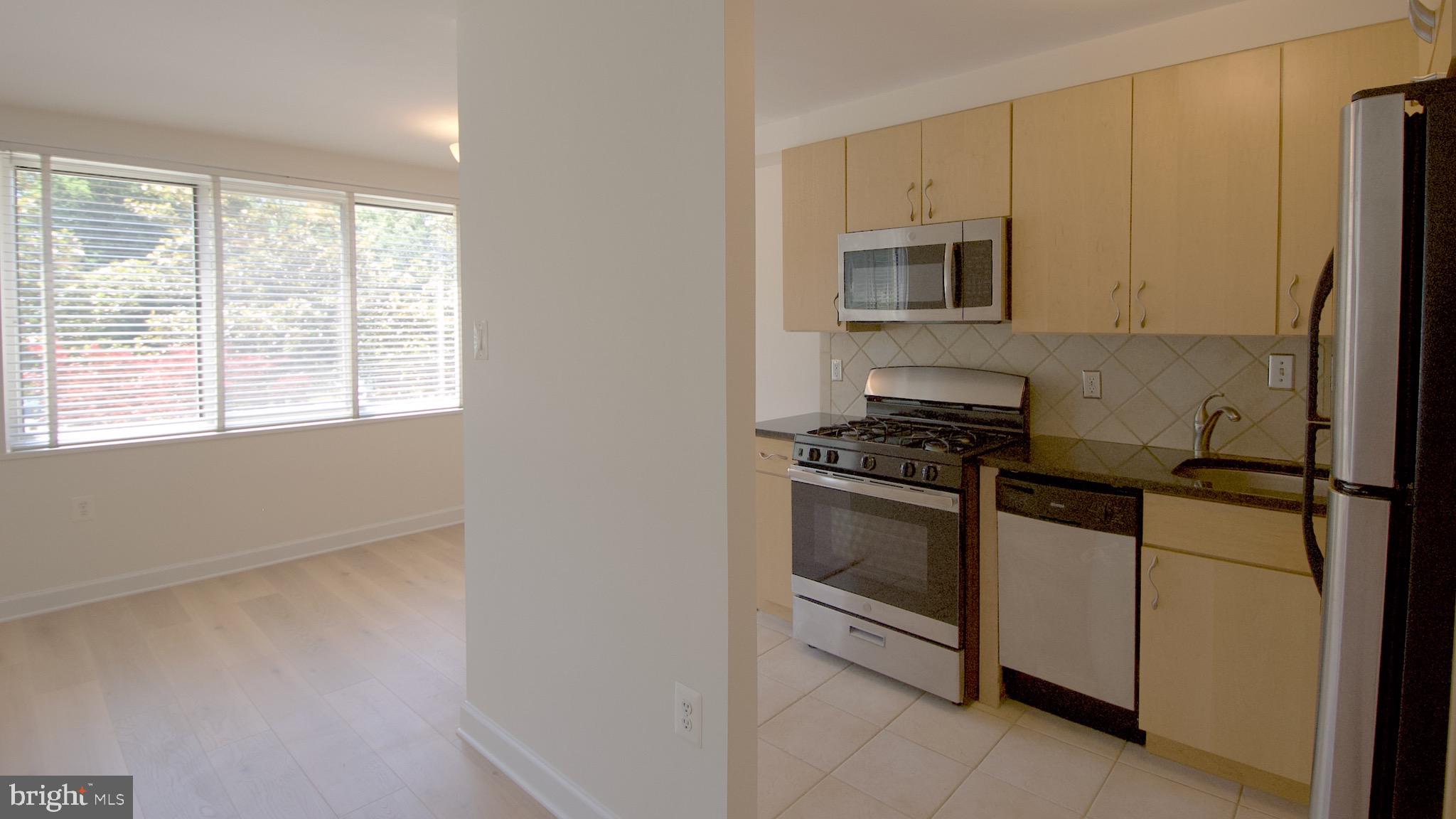 a kitchen with stainless steel appliances a refrigerator stove and microwave