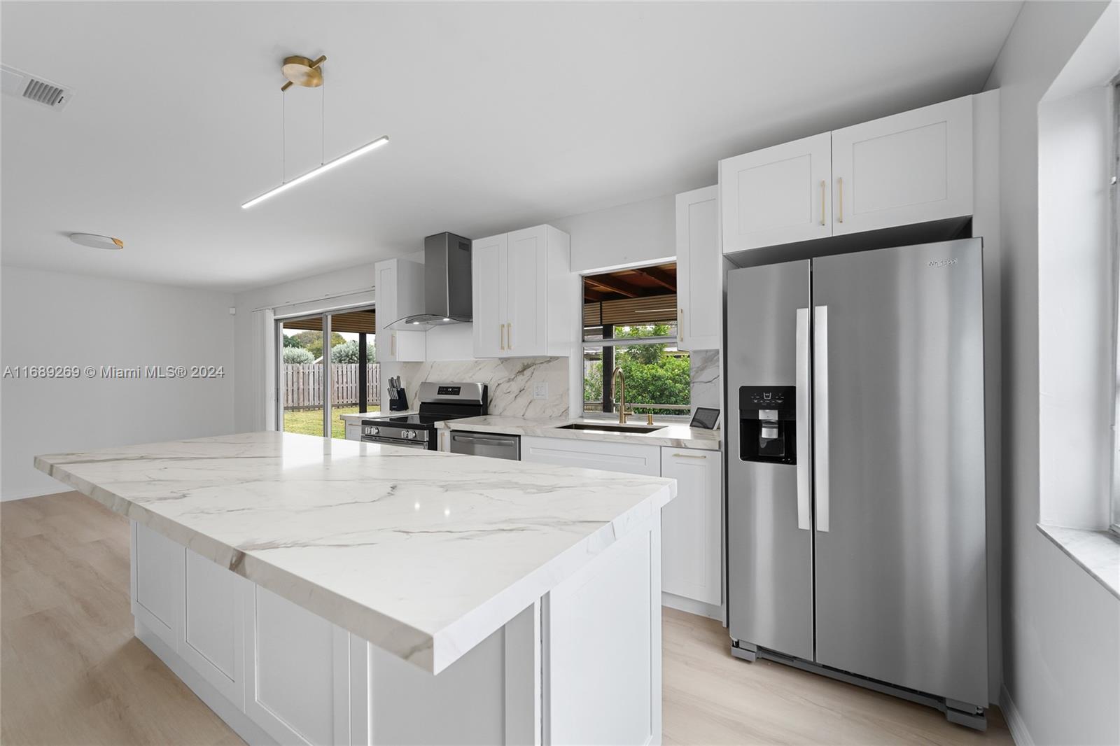 a kitchen with stainless steel appliances a refrigerator sink and stove