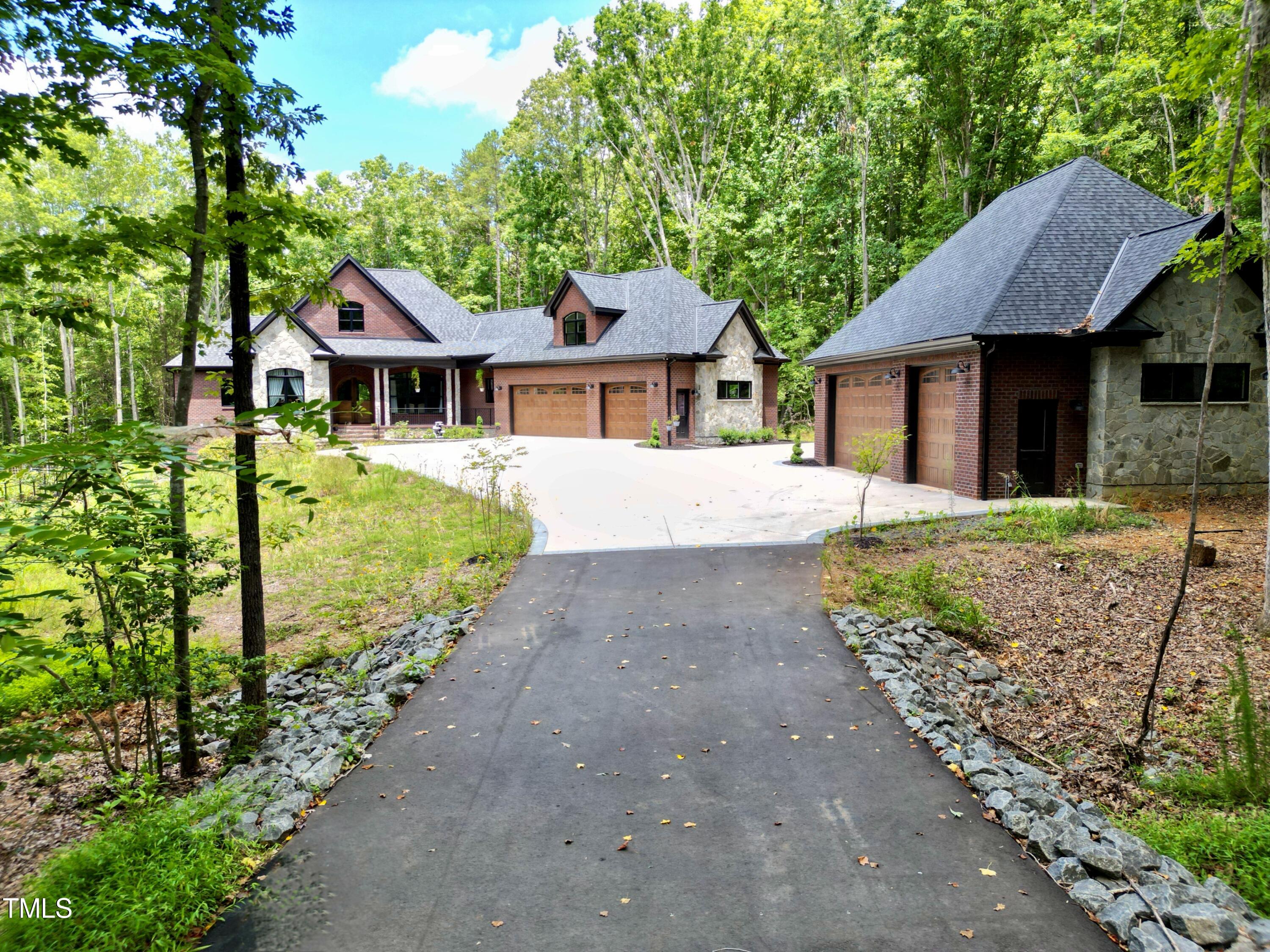 a front view of a house with a garden and yard