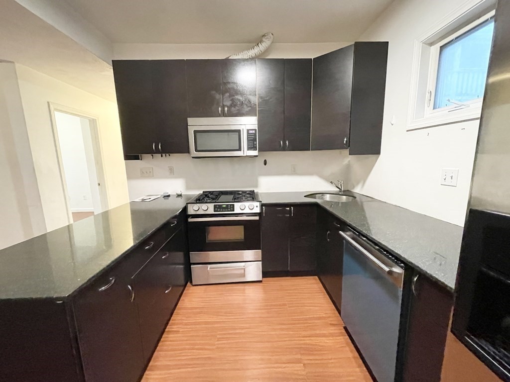 a kitchen with a sink and a stove top oven