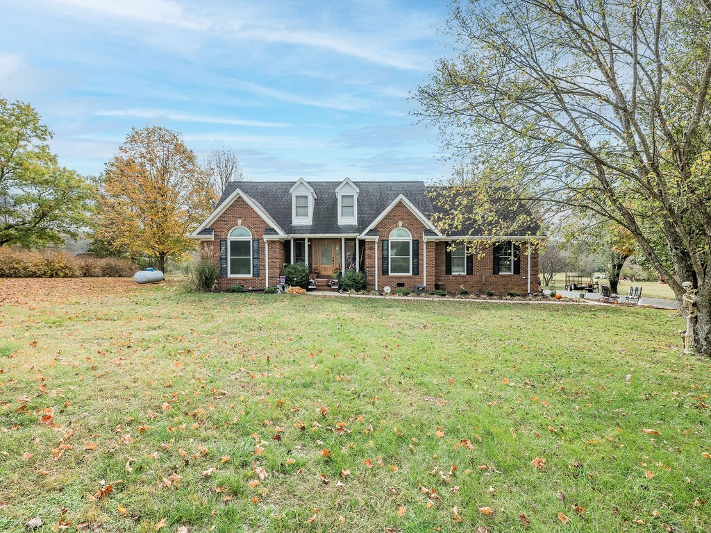 a front view of a house with a garden