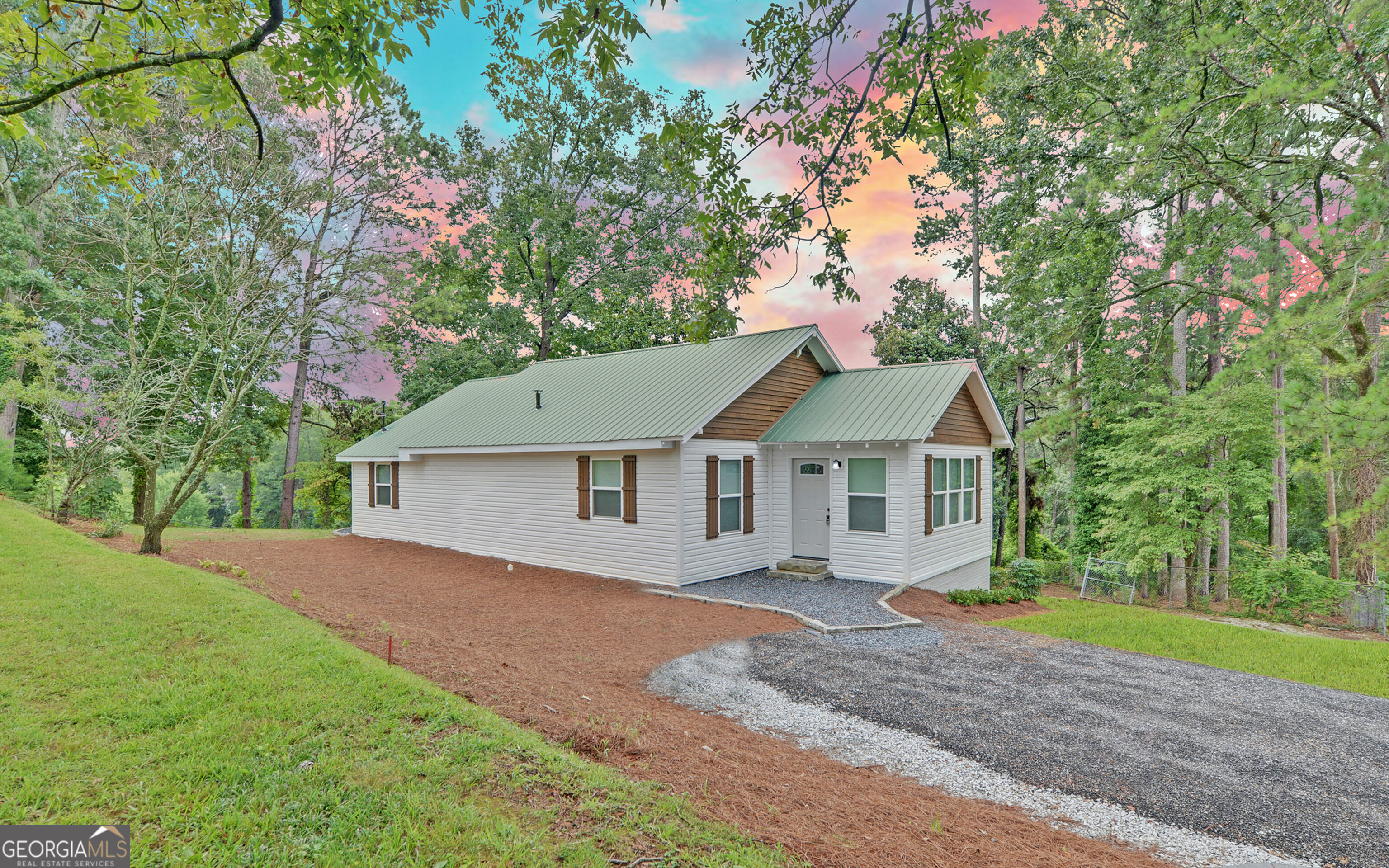 a front view of a house with a garden