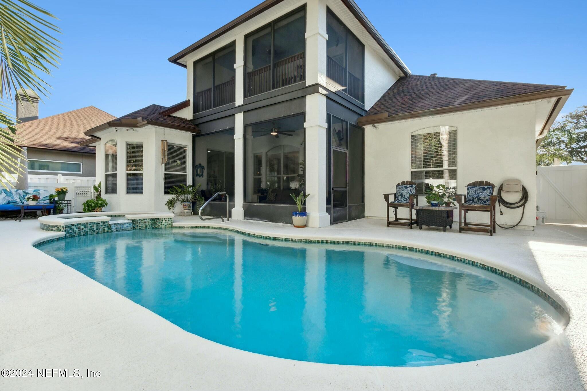 a view of a house with swimming pool and sitting area