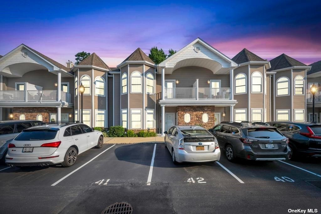 a view of a cars park in front of a building