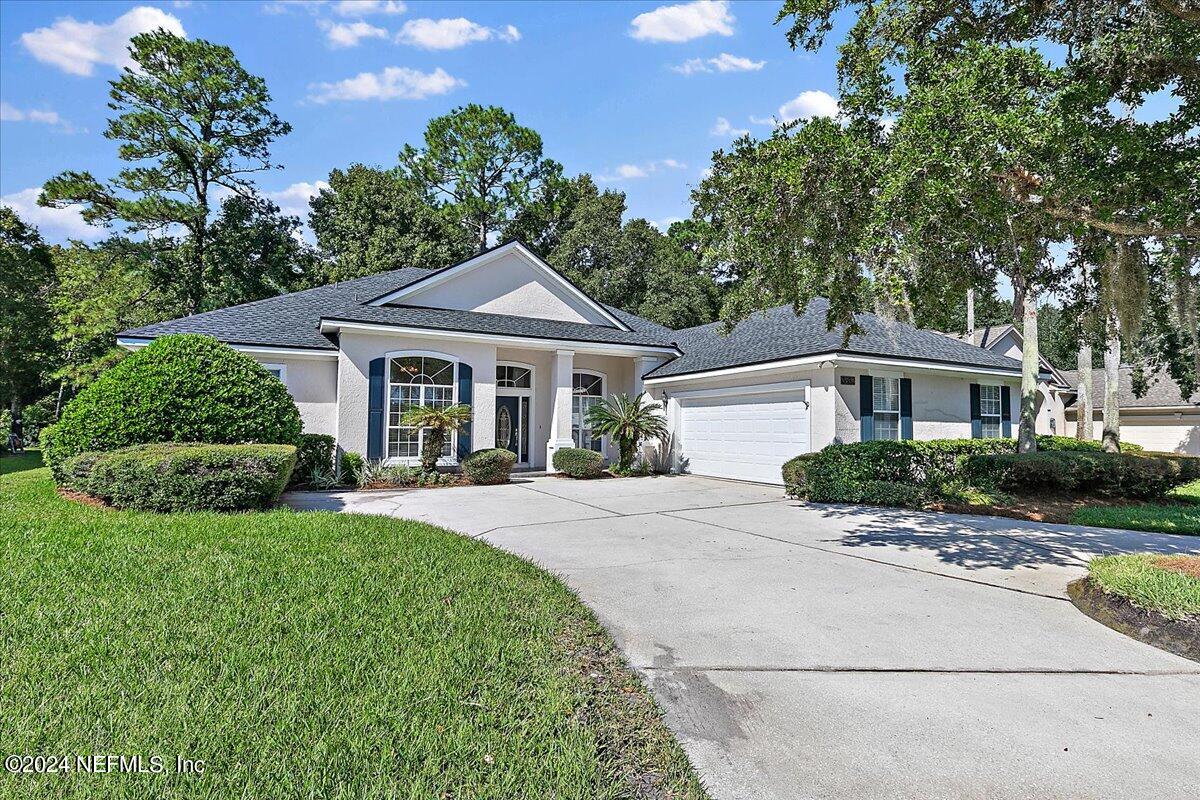 a front view of a house with yard porch and green space