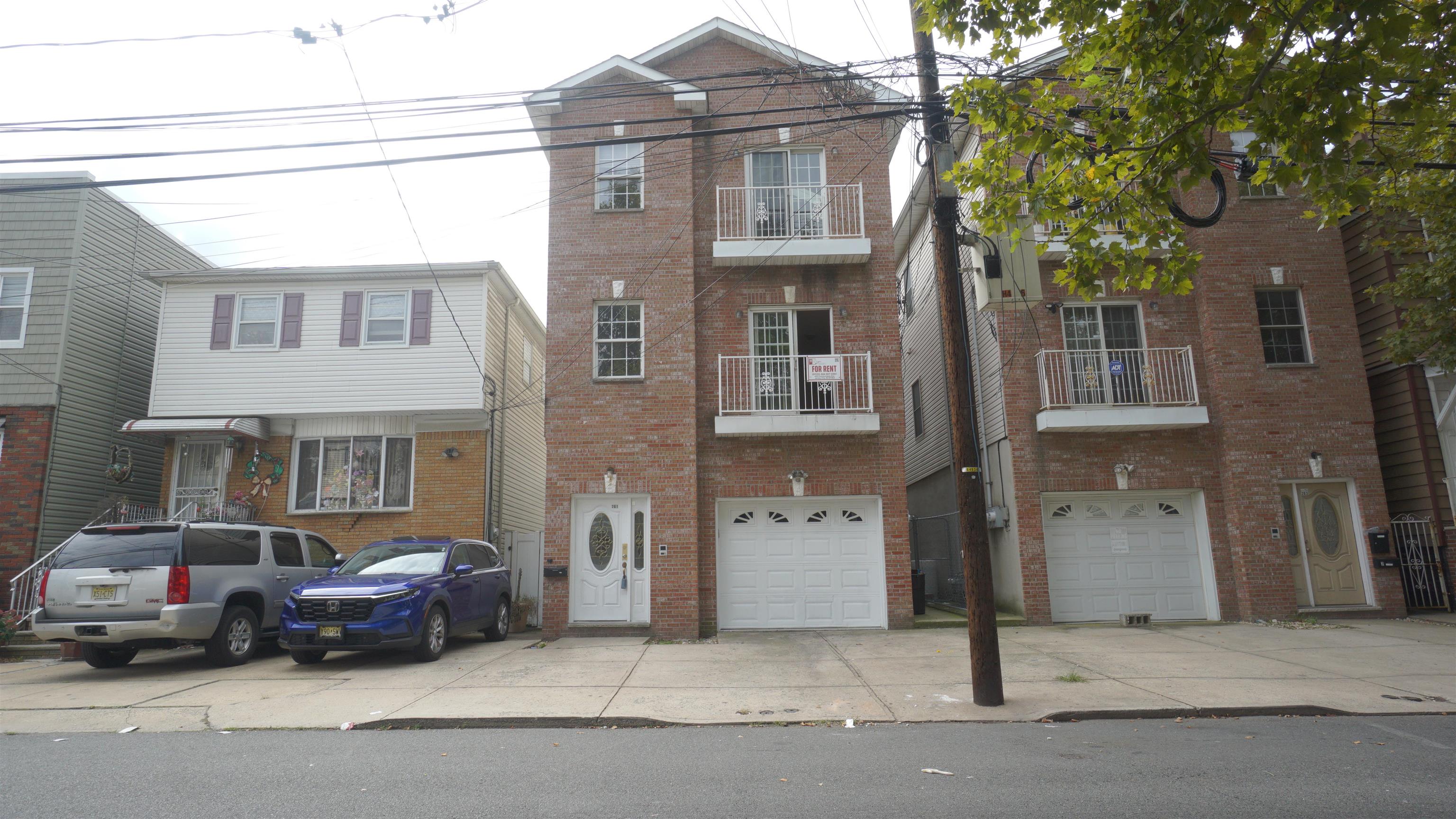 a car parked in front of a brick house