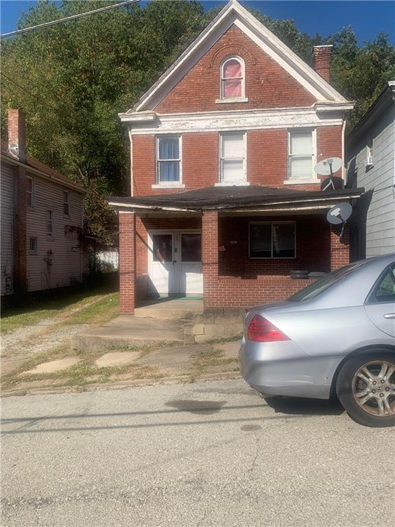 a front view of a house with parking space