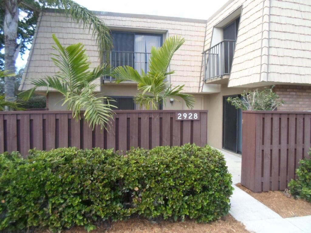 a view of a house with wooden fence