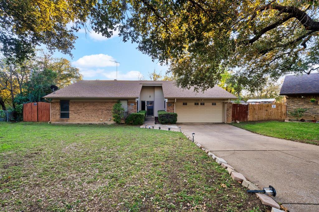 a front view of a house with a yard and a garage