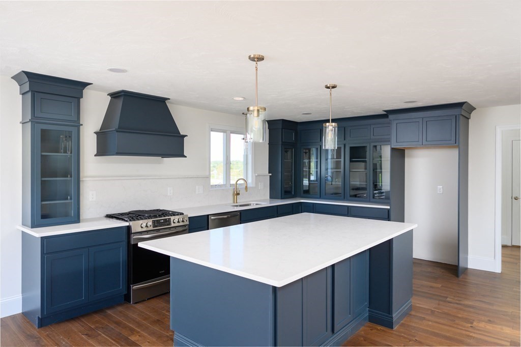 a kitchen that has a sink and a stove in it