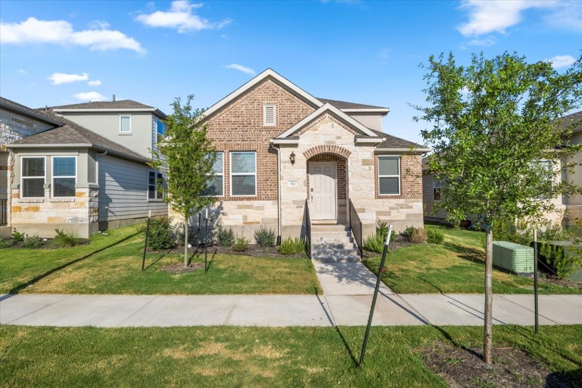 a front view of a house with a yard