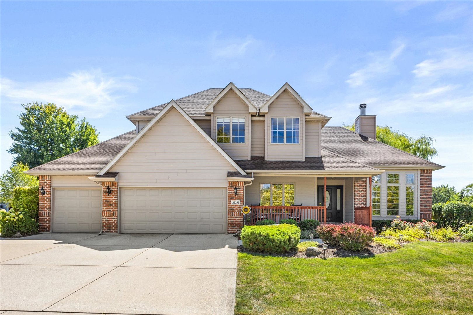 a front view of a house with garden