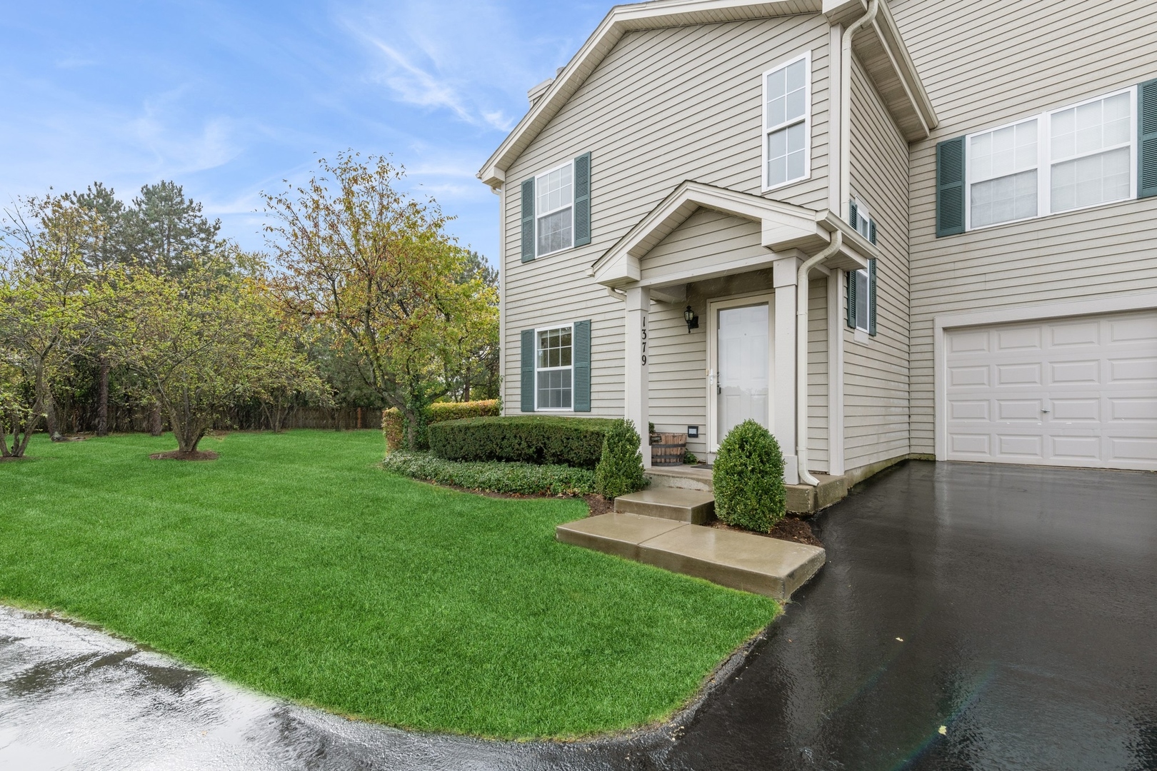 a front view of a house with a garden