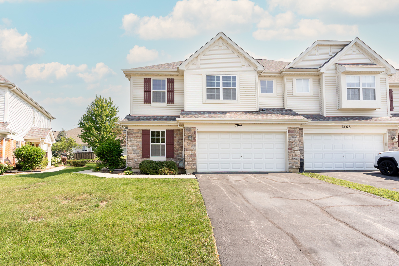 a view of a house with a yard and garage