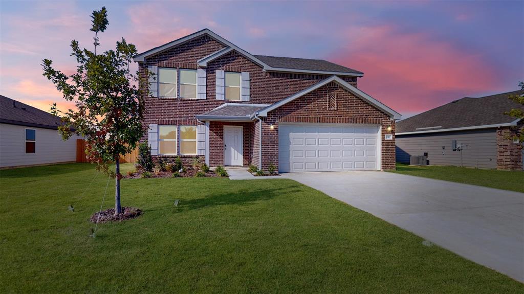 a front view of a house with a yard and garage