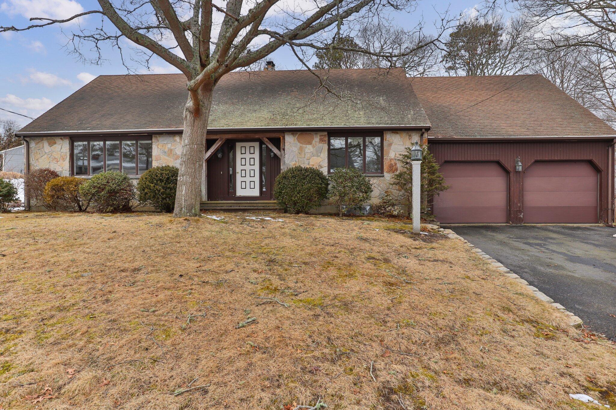 a front view of a house with a yard and garage