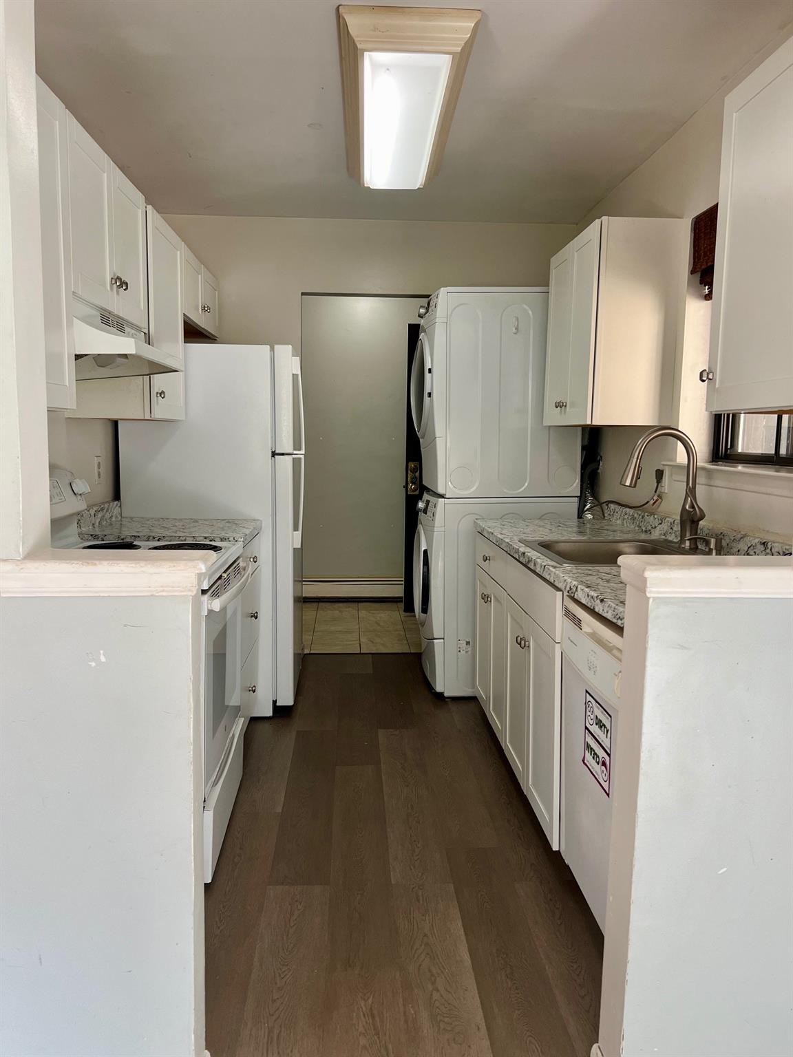 a kitchen with stainless steel appliances a refrigerator sink and cabinets