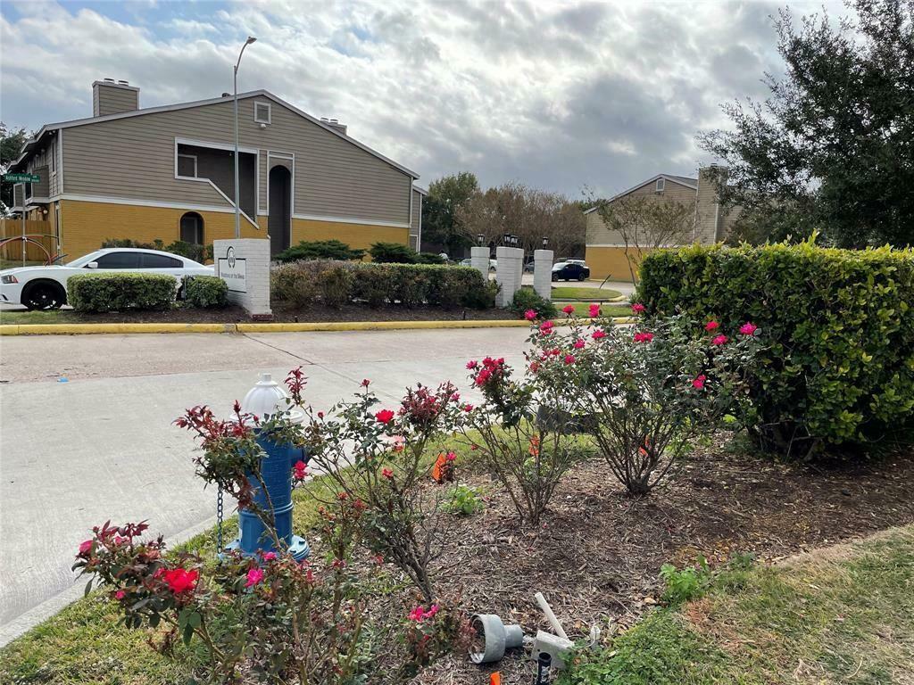 a front view of a house with a yard and fountain