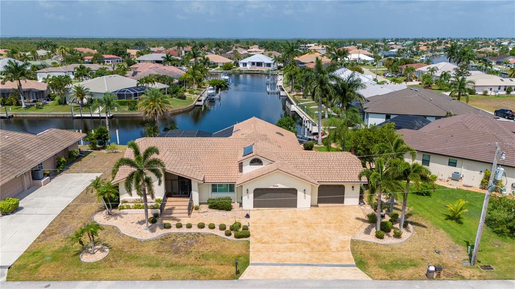 an aerial view of a house with garden space and street view