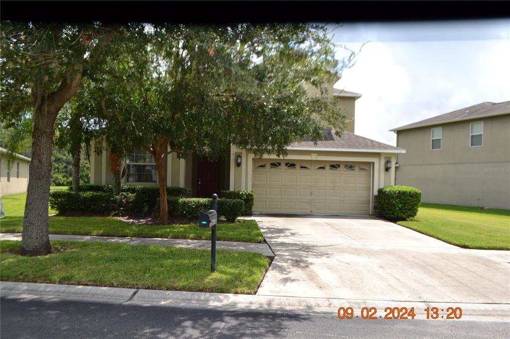 a front view of a house with a yard and garage