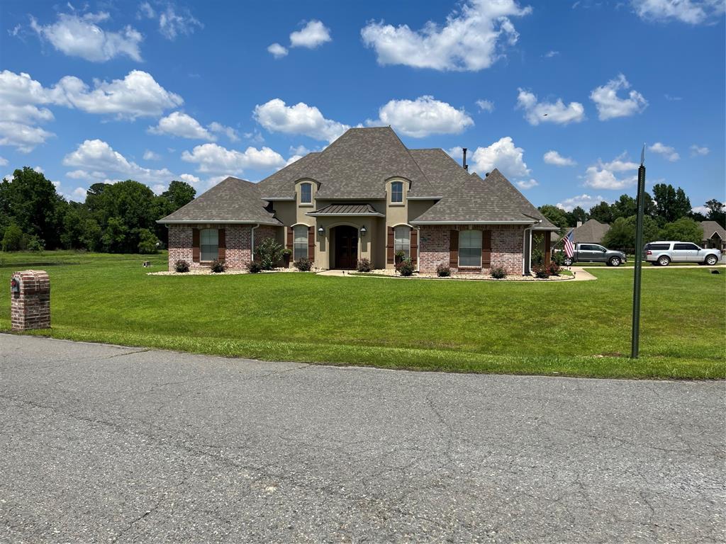 a front view of a house with a yard and garage