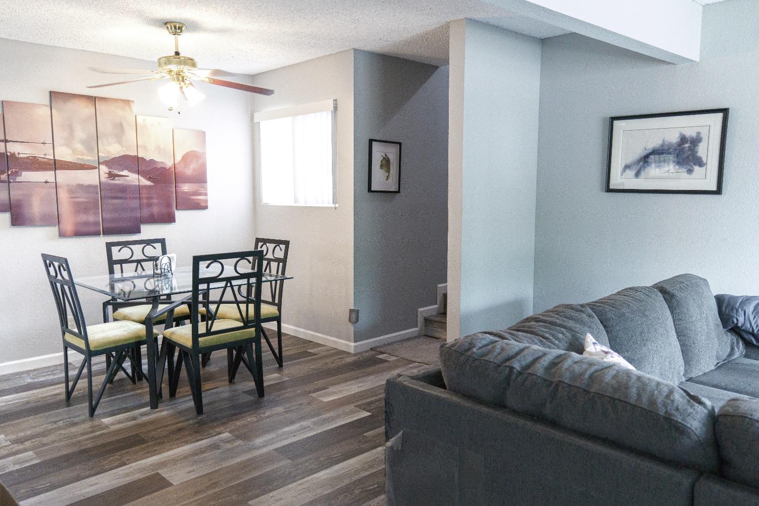 a living room with furniture a dining table and a rug