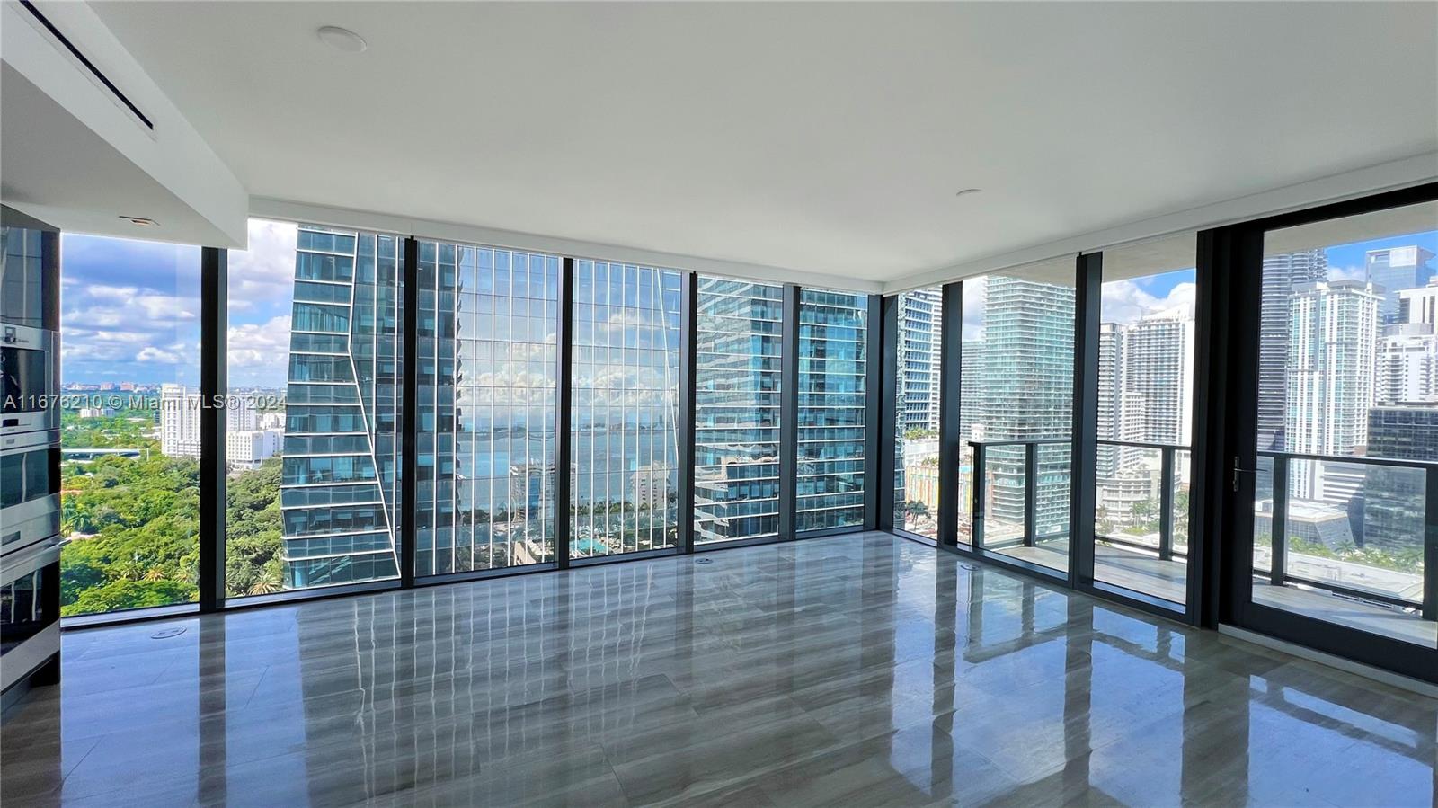 a view of entryway with floor to ceiling window and wooden floor