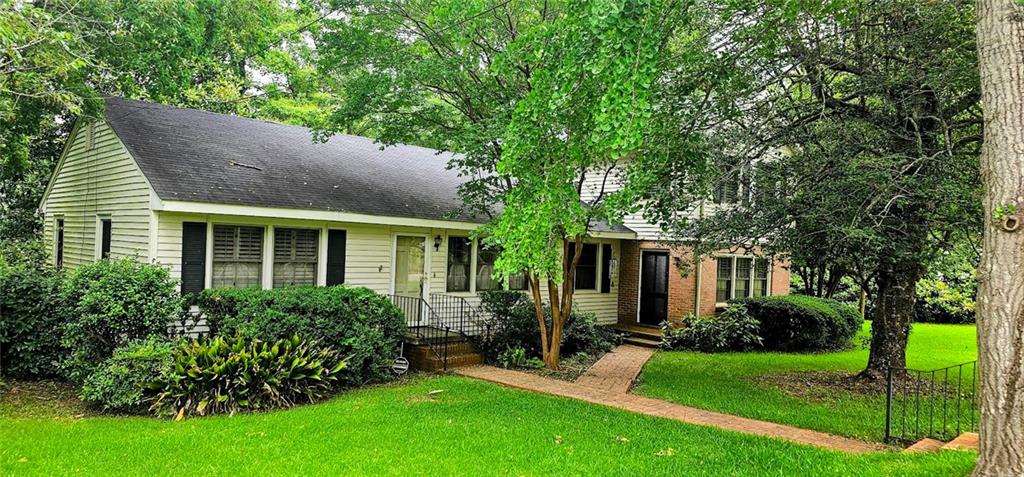 a view of an house with backyard space and garden