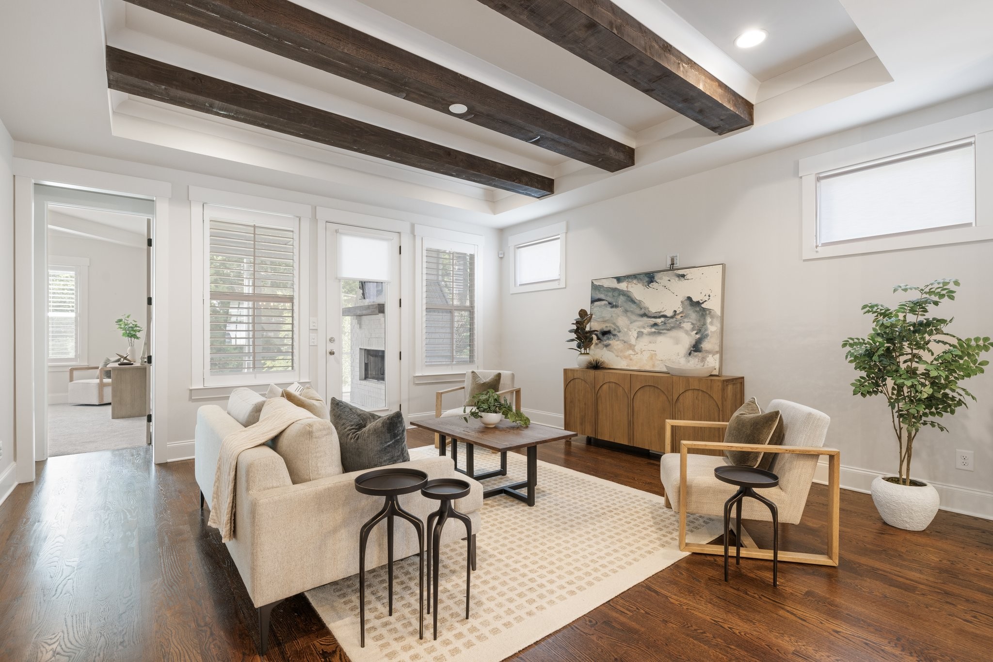 a living room with furniture and wooden floor