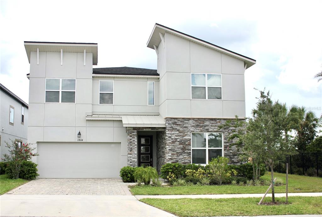 a front view of a house with a yard and garage