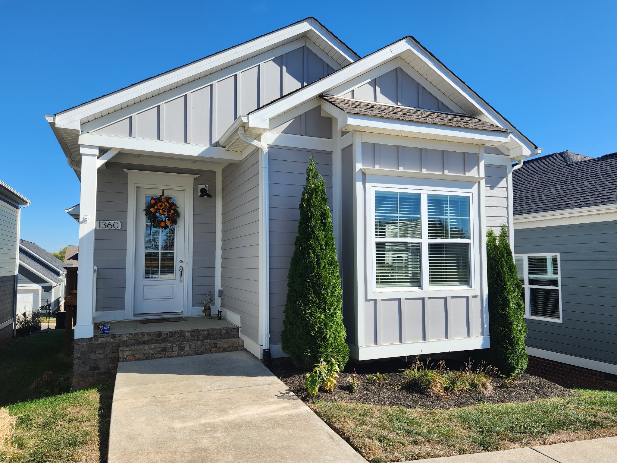 This beautiful cottage home lives large!  Neutral, upgraded finishes, open spaces, vaulted ceilings!