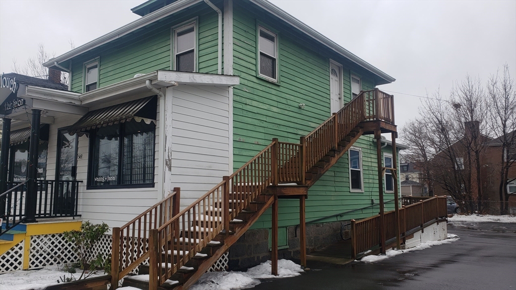 a view of a house with a wooden deck