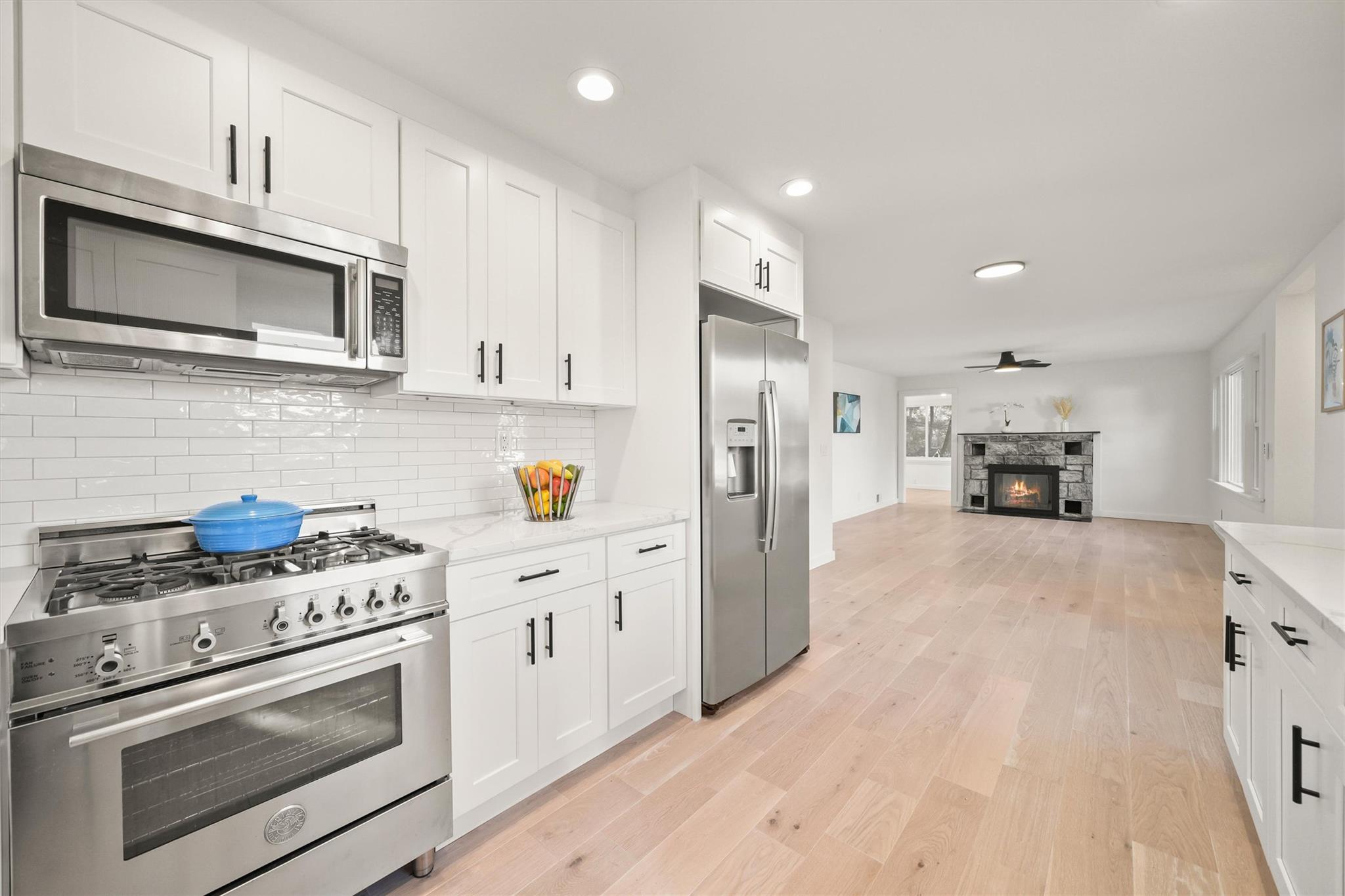 a kitchen with white cabinets and stainless steel appliances