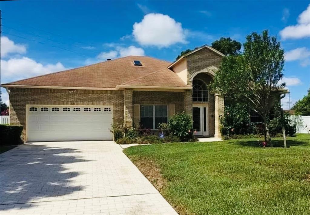 a front view of house with yard and green space