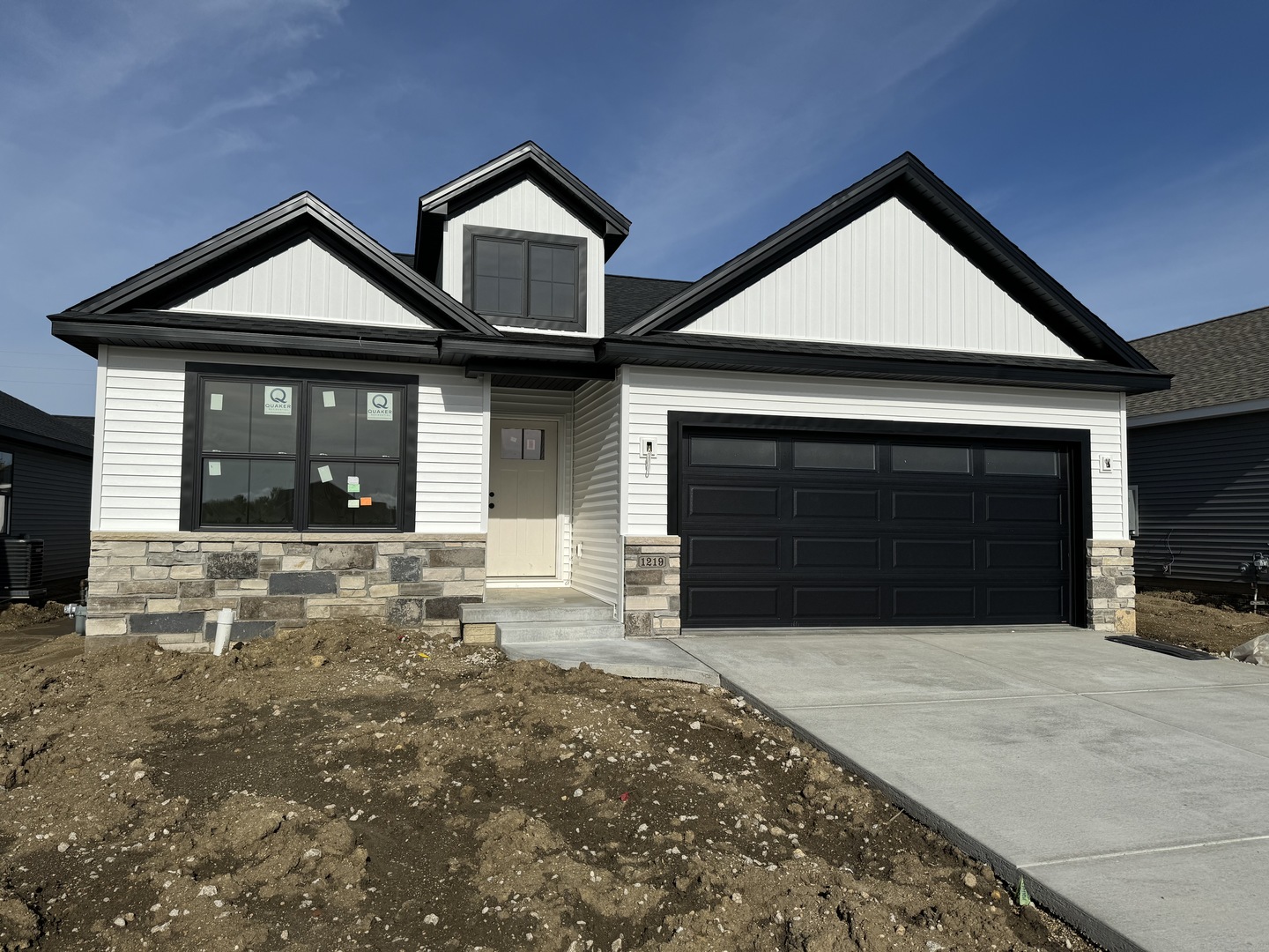 a front view of a house with yard and garage