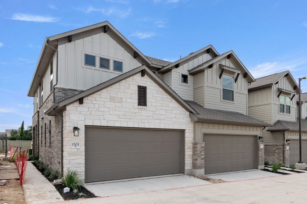 a front view of a house with garage