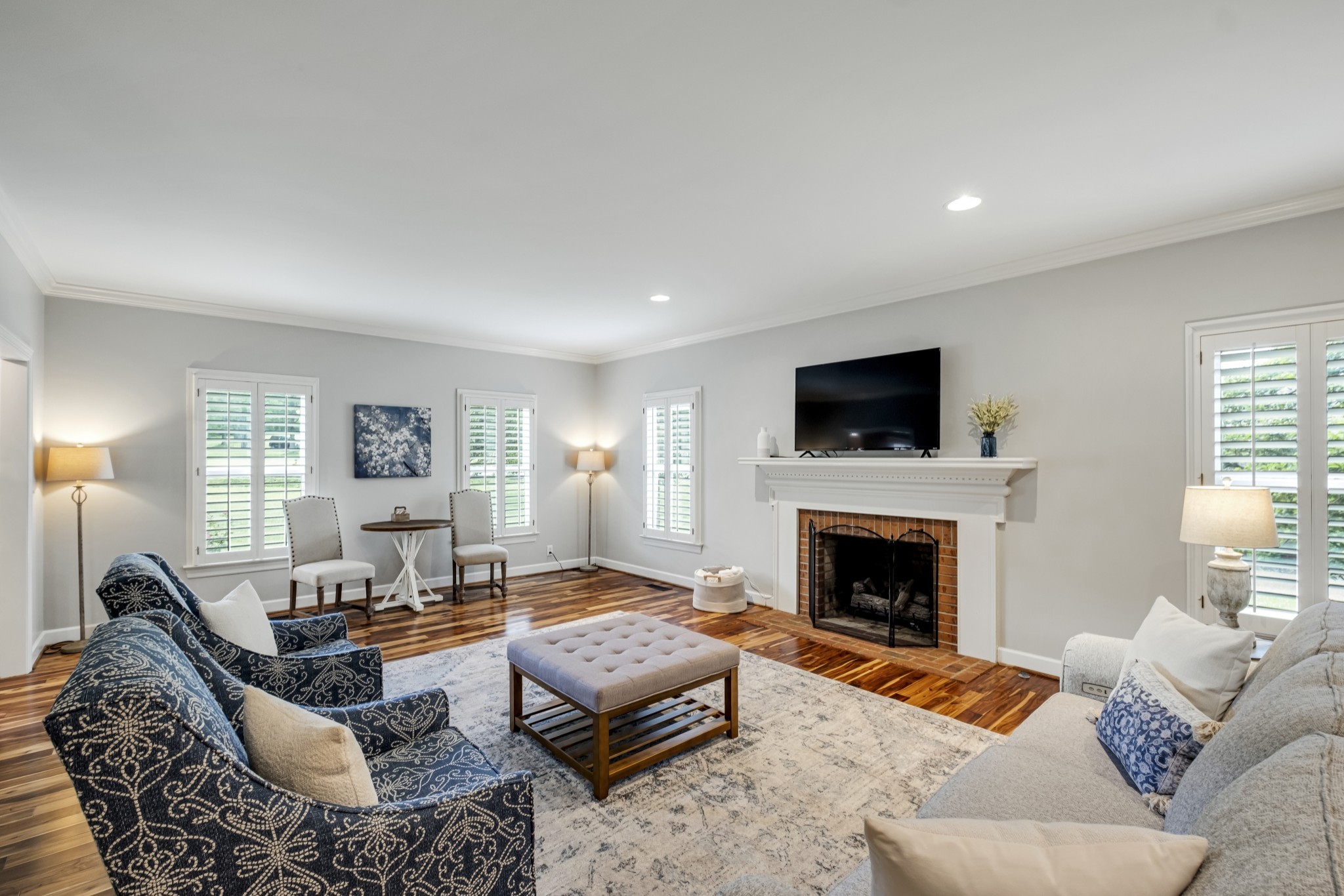 a living room with furniture flat screen tv and a fireplace